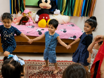 Children holding hands in a circle during a group activity